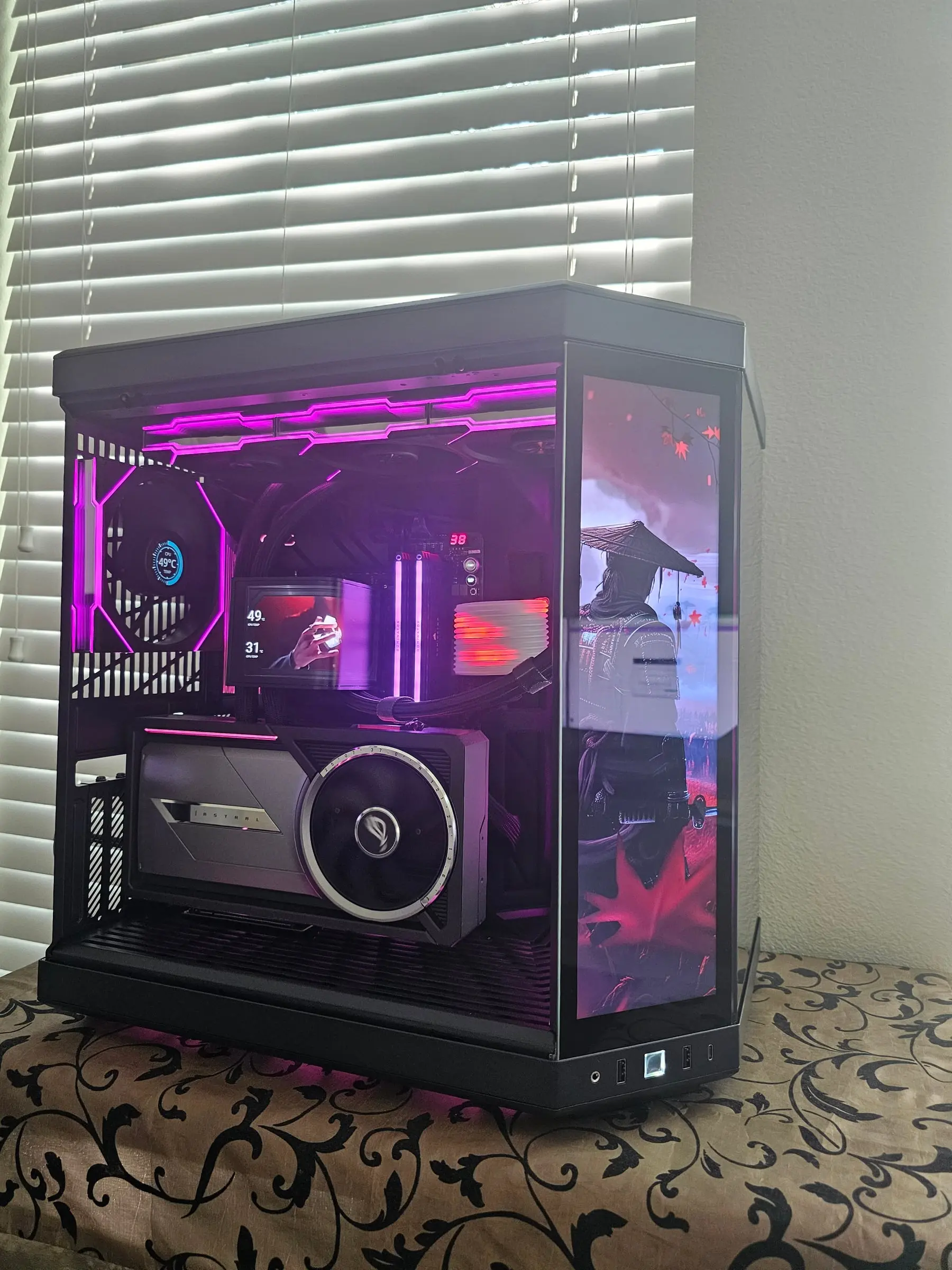 Magenta theme with samurai art — the Astral RTX 5090 LC and TRYX pump screen visible through the glass